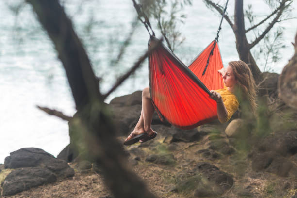 istock A single female relaxes in a hammock overlooking the ocean 858522126