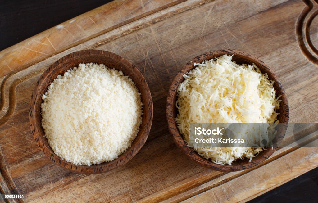 Bowls with grated parmesan cheese 2 Bowls with grated parmesan cheese  top view Grated Stock Photo