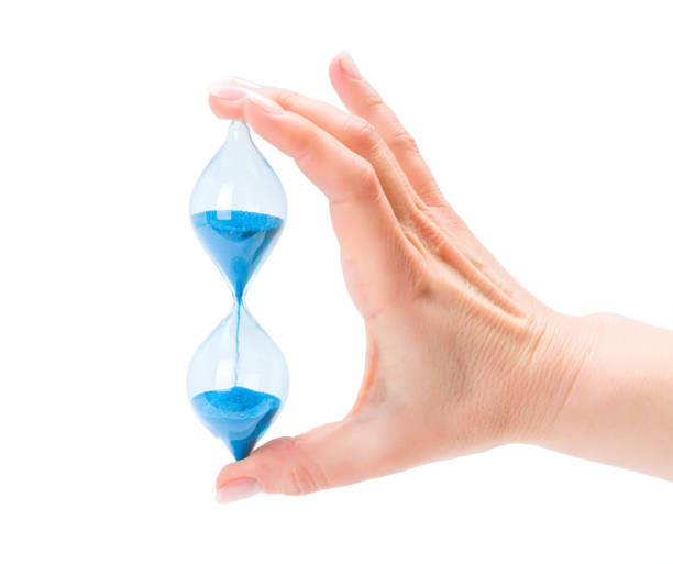 istock Woman's hand holding sand hourglass 858523188