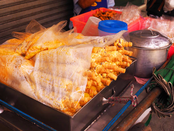istock Steamed corn in plastic bag piled up, in street stall cart 858523406