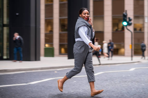 istock Businesswoman crossing road and using mobile phone 858526032