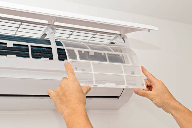 Air conditioning on a white wall Changing the Filter in the Air Conditioning The Concept of Safe and Healthy Housing air quality stock pictures, royalty-free photos & images