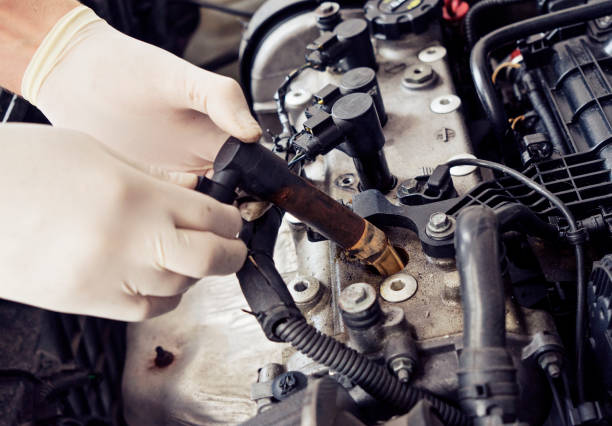 istock Close up man hand cheking car spark plug 858526204