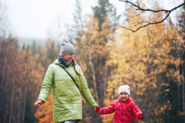 istock Mother with Daughter in the Autumn Forest 858534128