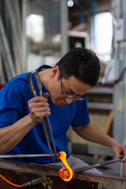 istock Man working at a glass factory 858535150
