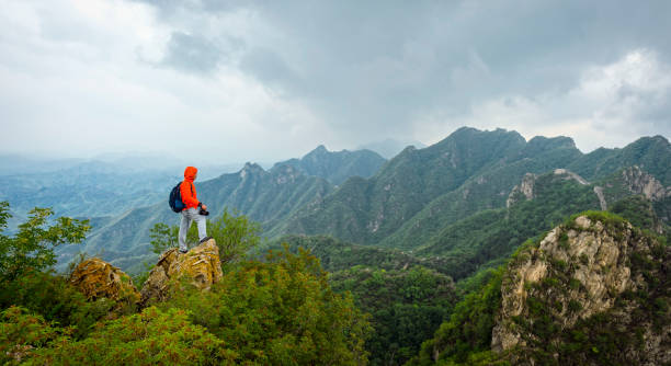 istock Strong mountain climber standing on the summit of a peak 858538374