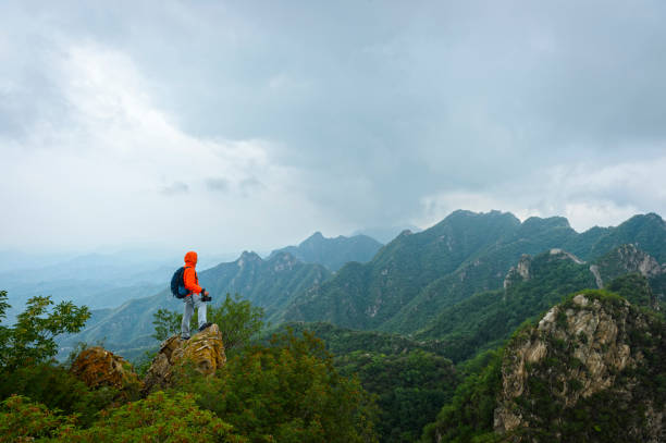istock Strong mountain climber standing on the summit of a peak 858538382