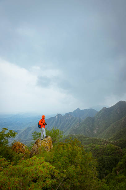 istock Strong mountain climber standing on the summit of a peak 858538506