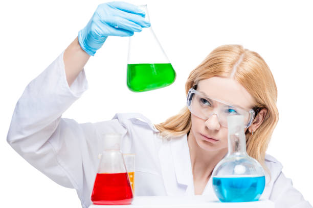 A professional chemist with test tubes in glasses and gloves makes an analysis