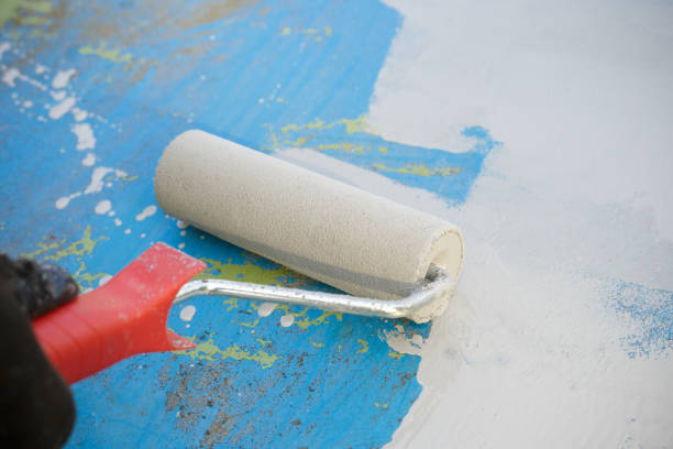 istock Close up of paint roller painting a metal surface 858541508