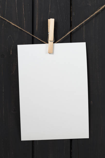 istock Blank white paper cards hanging on clothespins 858541928