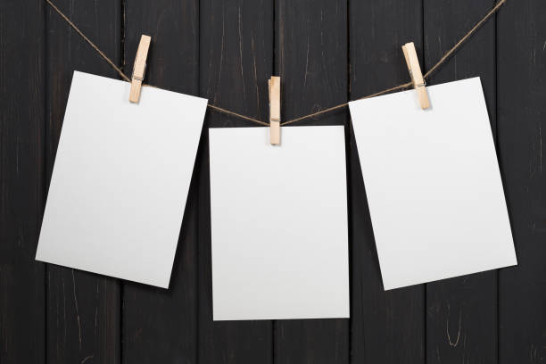 istock Blank white paper cards hanging on clothespins 858544168