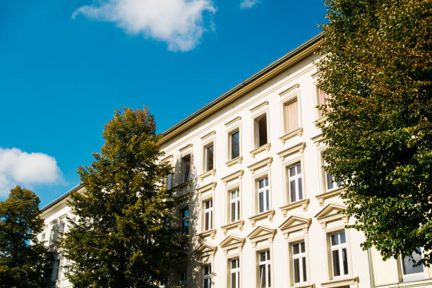 istock yellow residential building with trees 858544312