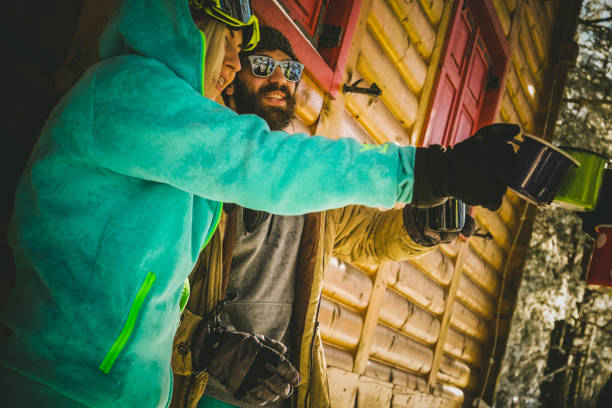 istock Snowboarders making toast with hot tea 858544810