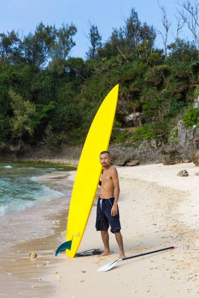 Surfboard near orange wall with place for text. 3d-rendering