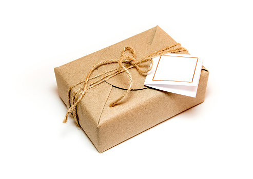 Brown gift box wrapped in kraft paper and rustic hemp cord as natural rustic style with paper your note