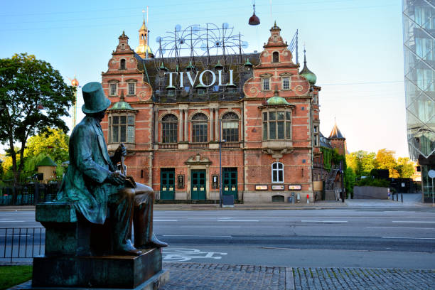 Entrance of Tivoli Gardens, Copenhagen Statue of Hans Christian Andersen looking over the entrance of Tivoli Gardens, Copenhagen, Denmark hans christian andersen stock pictures, royalty-free photos & images