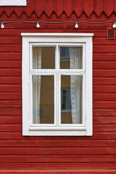 istock Traditional red wooden facade with white window. Vintage background 858545828