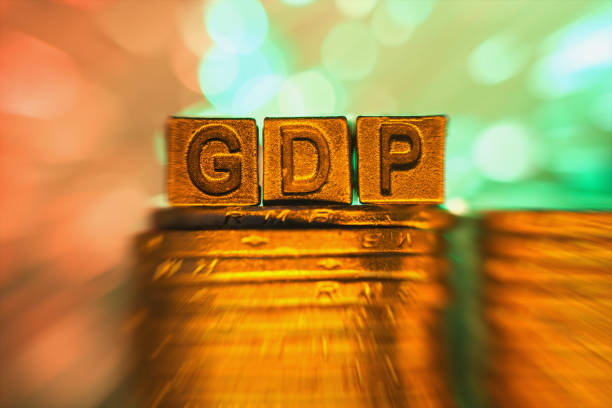 istock GDP copper alphabet on coin stack in radial blur illuminated with light 858549024