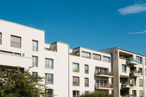 istock white and modern flat buildings with copy space in the sky 858550534