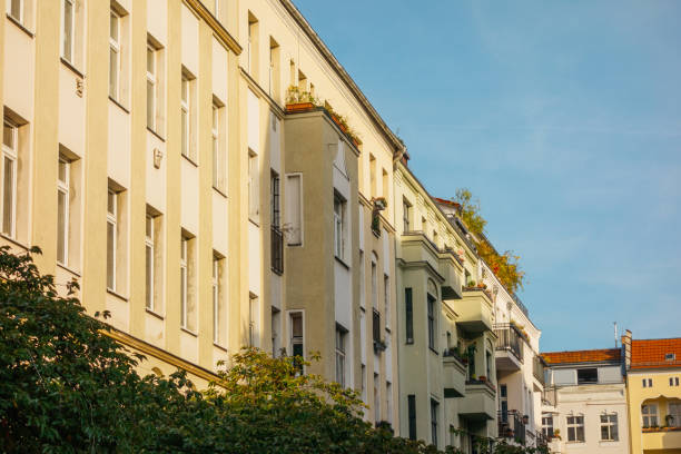 istock yellow apartment house with shadow on the facade 858553916