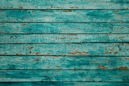 Vintage wood background with blue peeling paint.