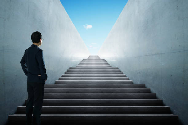 istock Businessman looking and thinking front of a stair infinty view . 858564802