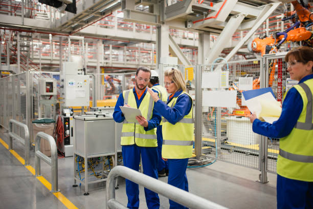 istock Trainee Factory Worker in Action 858568390