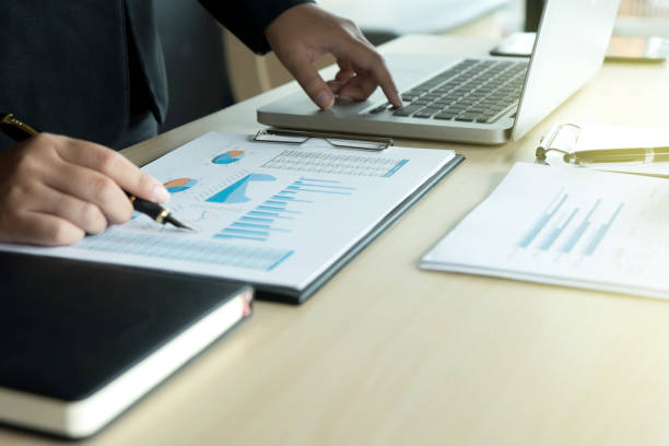 istock business man working with laptop on wood table 858568924