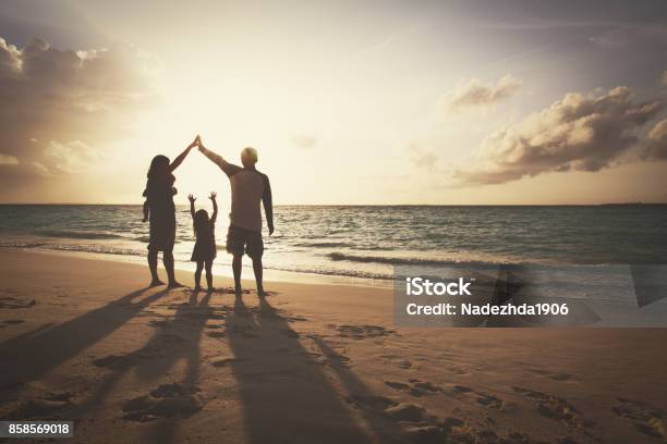 Happy Family With Kids Play At Sunset Beach Stock Photo - Download Image Now - Family, Beach, Insurance