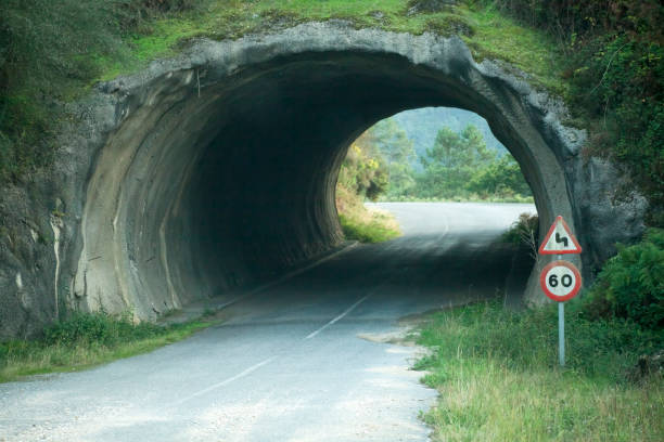 istock Empty country road in bad condition, road signs, tunnel. 858569360