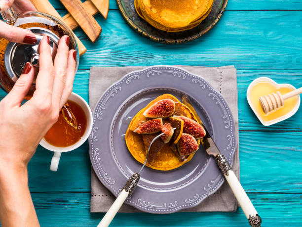 istock Eating pumpkin pancakes with figs and honey 858569464