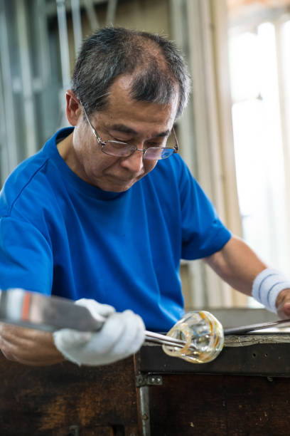 istock Man working at a glass factory 858569636