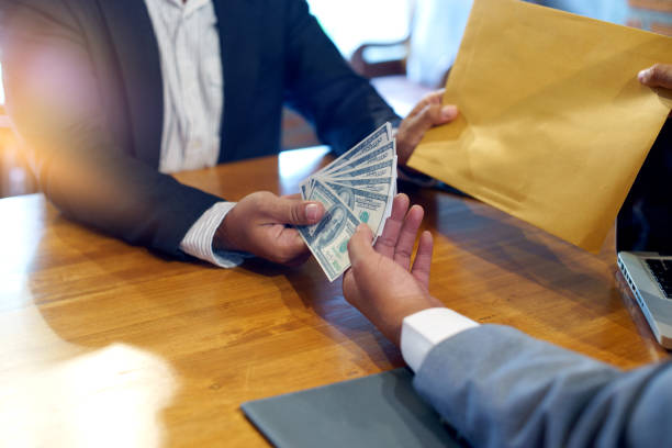 istock Business man give bribe to the officer 858572394