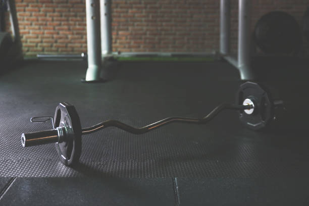 istock Barbell on the Floor in GYM.Dark background 858575506