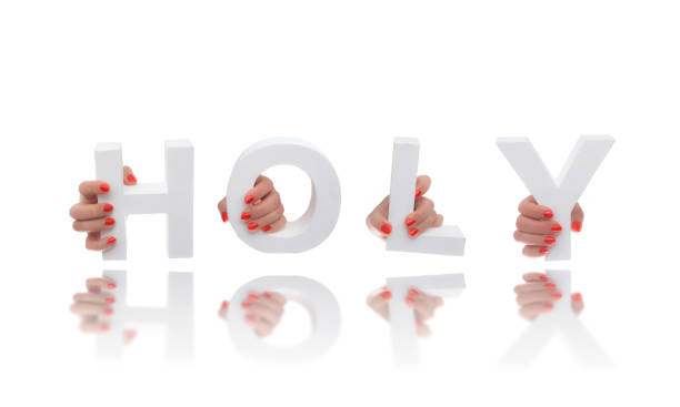 istock Hands holding up the positive word Holy 858575576
