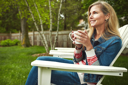 Shot of a mature woman sitting in her backyard