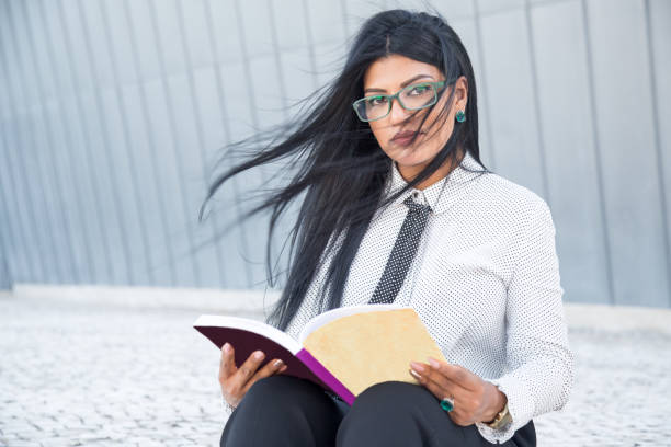 istock Confident smart woman reading business book 858587734
