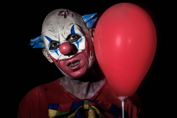 istock scary evil clown with a red balloon 858590792