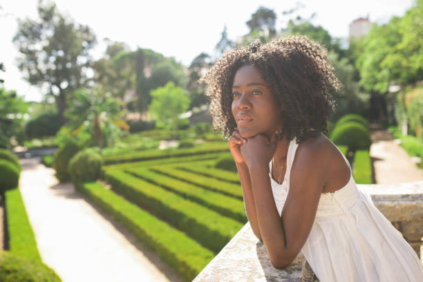 istock Dreamy Pretty Black Woman Relaxing in Park 858591330