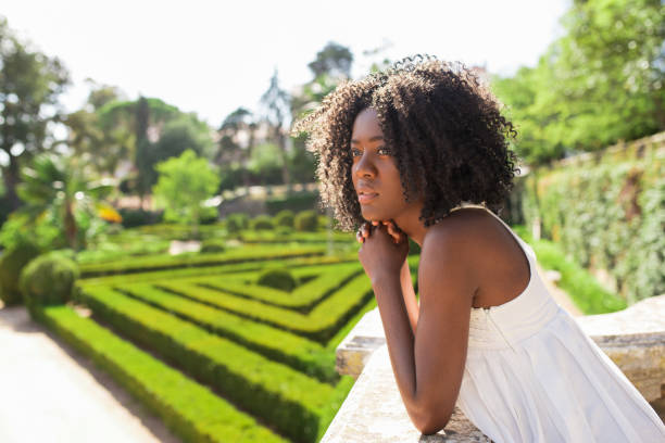 istock Pensive Young Black Woman Relaxing in Park 858591400
