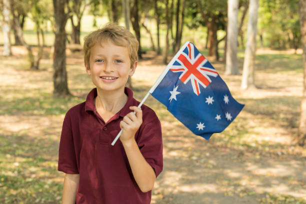 istock Australian Flag Waving by Primary School Boy Student for Australia Day 858591750