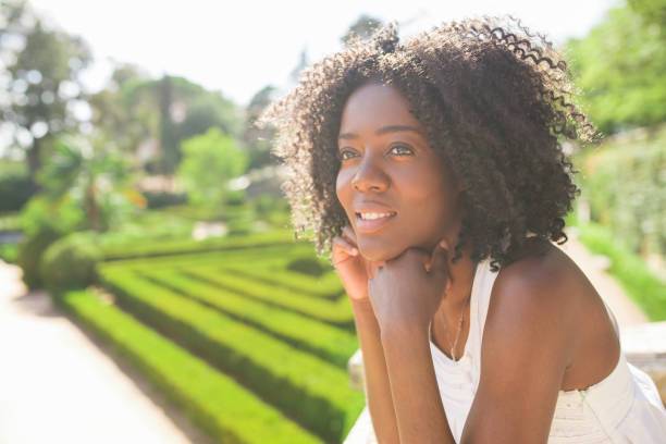 istock Smiling Pretty Black Woman Relaxing in Park 858591800