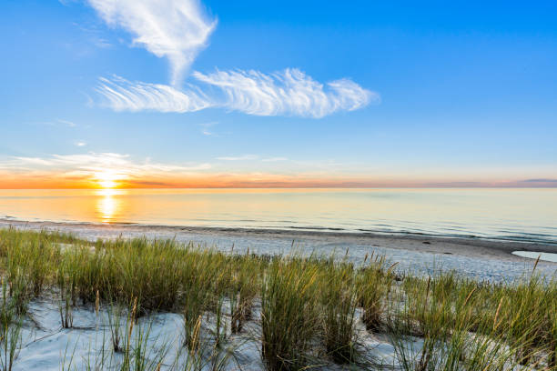 istock Sandy beach and sunset sky with golden sun shining on white sand 858594354