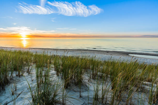 istock Sandy beach and sunset sky with golden sun shining on white sand 858594736