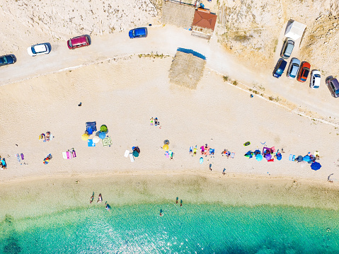 Aerial view of people enjoying at Drazica beach at island of Pag, Croatia.