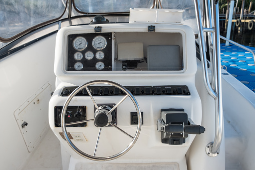 White yacht speed control panel with steering wheel