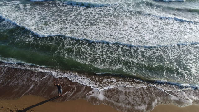 High angle view of man walking on the beach