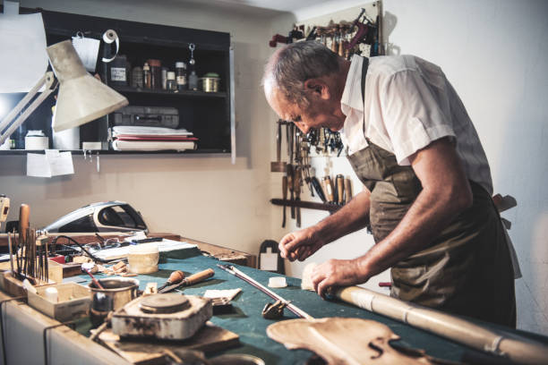 istock Senior man working in music instrument shop 858599512