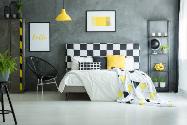 istock Spacious bedroom with yellow accessories 858599520
